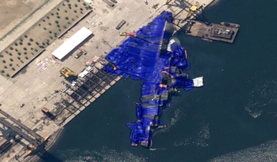 A North Korean destroyer after a failed launch. It has been covered with blue tarps.
