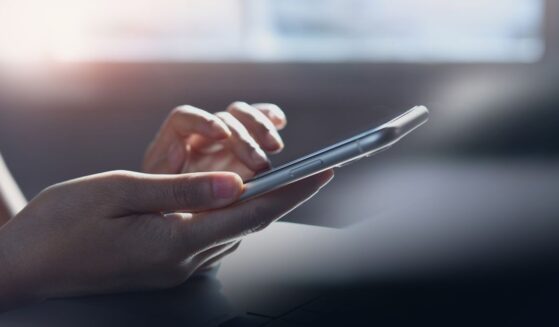Closeup, woman hand using mobile smartphone, surfing the internet, web browsing via mobile app, social media, network, side view, internet technology, online marketing