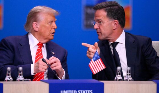 President Donald Trump, left, and NATO Secretary General Mark Rutte, right, speak at the start of a NATO leaders summit in The Hague, Netherlands, on Wednesday.