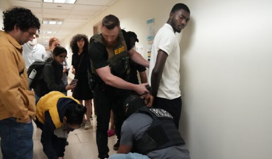 Immigration and Customs Enforcement agent detain a migrant after his court appearance June 27 at the Federal Plaza courthouse in New York City.